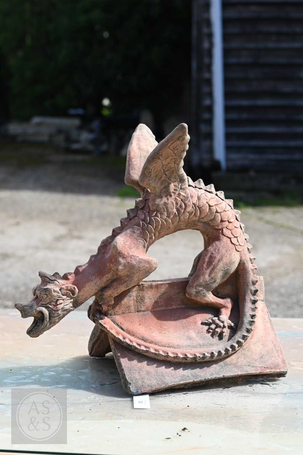 A cast terracotta dragon ridge tile, 47 cm x 43 cm high