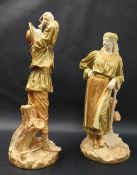 A pair of Royal Worcester blush ivory figures including one of a female figure standing in front of