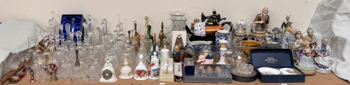 A collection of glass hand bells together with a sewing machine teapot, steins, pottery figures,