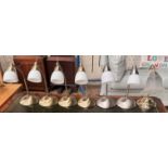 A set of four brass table lamps with opaque glass shades together with a pair of satin steel table