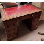A Victorian mahogany pedestal desk with a rectangular leather inset top,