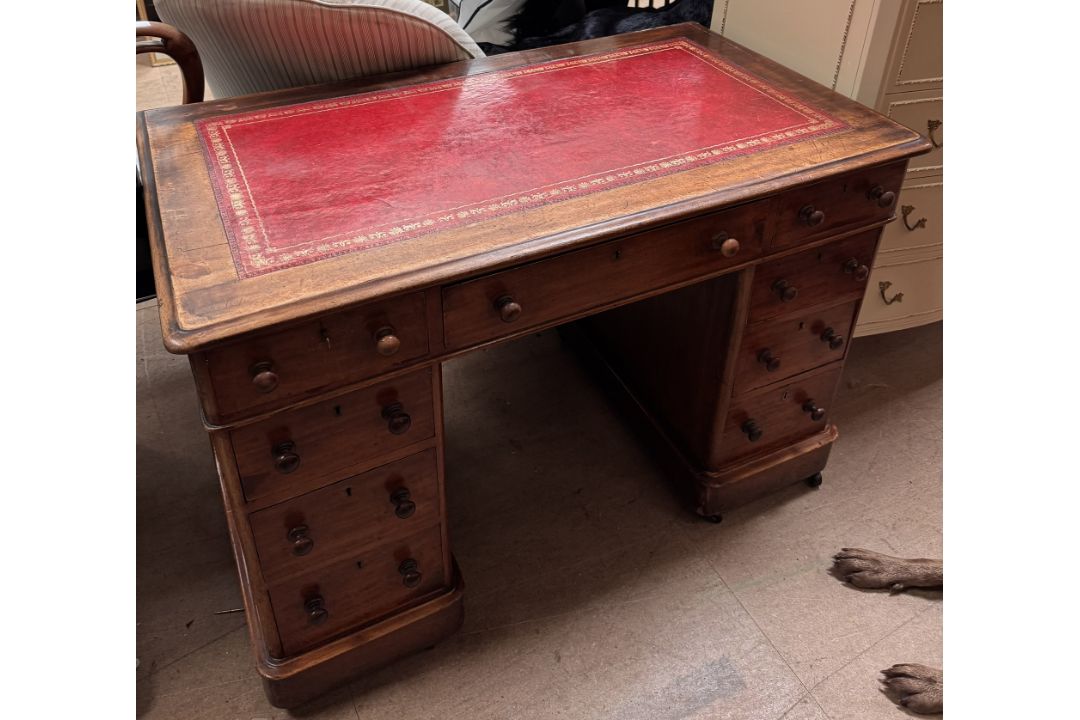 A Victorian mahogany pedestal desk with a rectangular leather inset top,