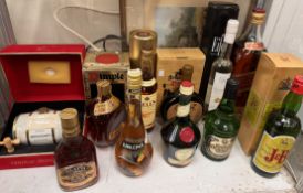A cask of Hennessy Napoleon Cognac contained in a red velveteen case together with other bottles of