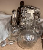 Two silver topped decanters together with three other decanters , fireside tidy, tray,