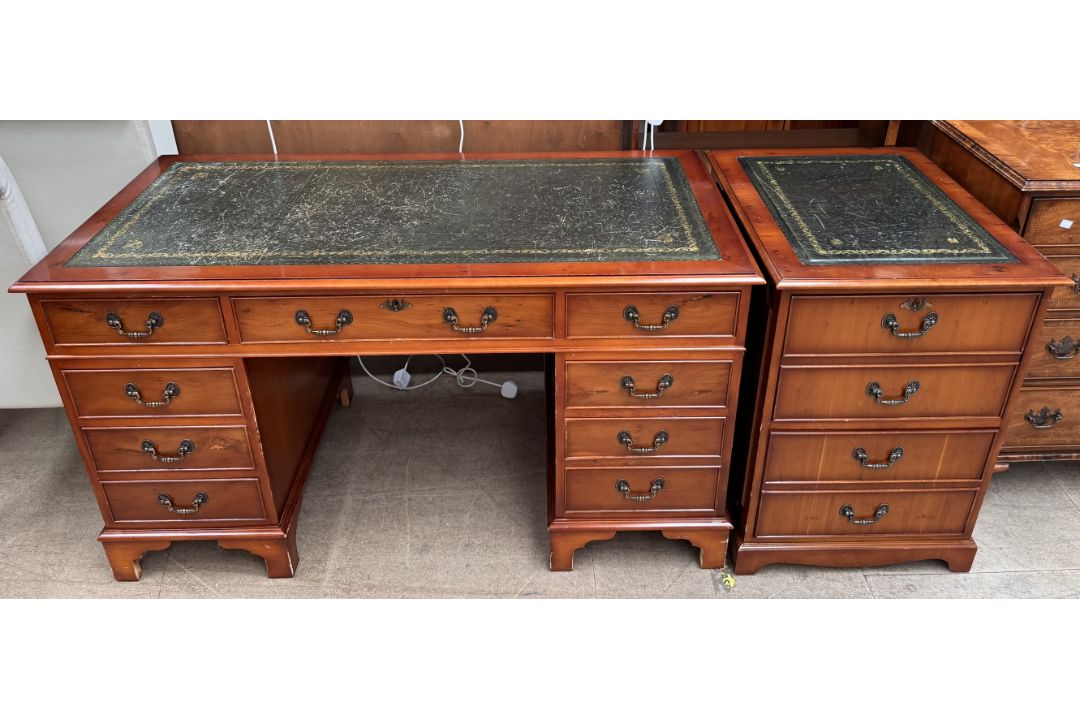 A reproduction yew pedestal desk together with a matching filling cabinet
