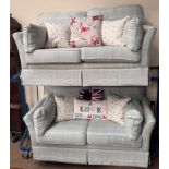 A pair of upholstered two seater settees in blue with a chequer pattern