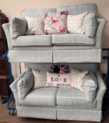 A pair of upholstered two seater settees in blue with a chequer pattern