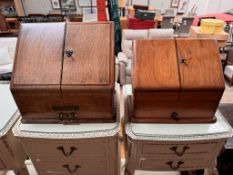 An Edwardian oak table top stationery cabinet with a sloping front enclosing compartments,