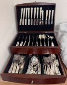 An electroplated Kings pattern part flatware service contained in a hinged cabinet with a base