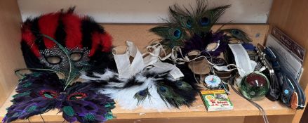 Feather masks together with a paperweight etc