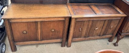 An oak coffer with a three panelled front on square legs together with another oak coffer