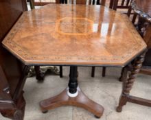 A Victorian tripod table with an hexagonal inlaid top above an ebonised column and trefoil base