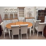A modern oak and cream painted kitchen table and eight chairs together with a matching sideboard,