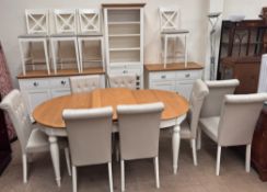 A modern oak and cream painted kitchen table and eight chairs together with a matching sideboard,