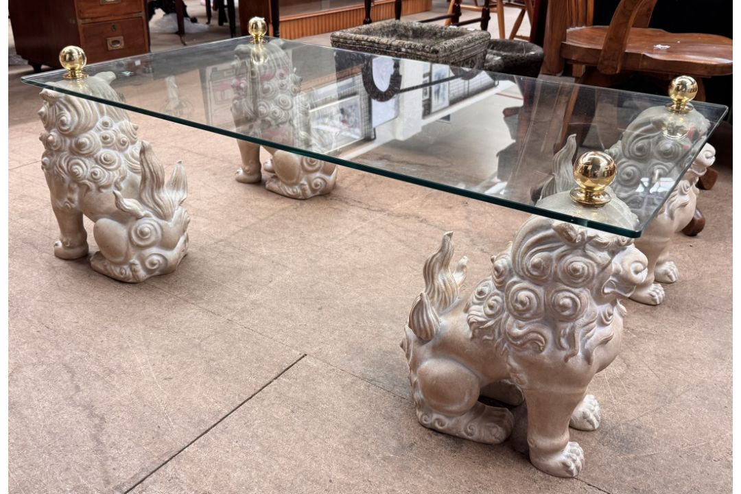 A glass topped coffee table with a rectangular top on four seated dog of foo legs, 122cm x 68. - Image 1 of 2