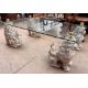 A glass topped coffee table with a rectangular top on four seated dog of foo legs, 122cm x 68. - Image 1 of 2