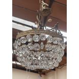 A brass and cut glass basket chandelier