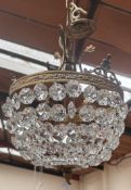 A brass and cut glass basket chandelier