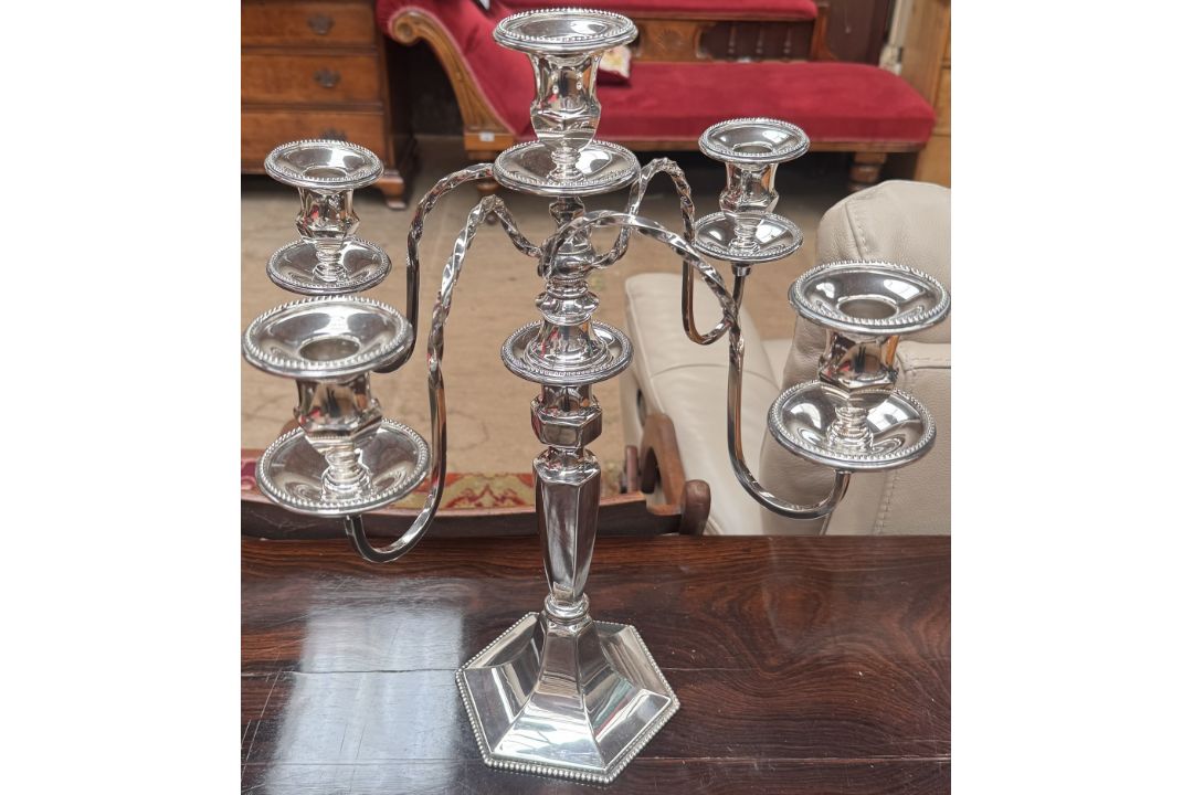 An electroplated four branch chandelier, on an hexagonal beaded base, 44.