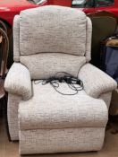 A cream upholstered electric recliner chair