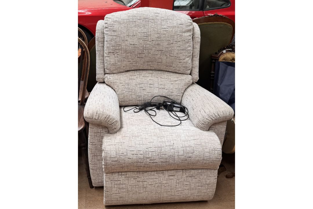 A cream upholstered electric recliner chair