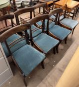 A set of six Regency mahogany swag carved bar back dining chairs with drop in seats on sabre legs