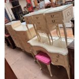 A cream painted part bedroom suite comprising a dressing table,