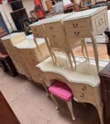 A cream painted part bedroom suite comprising a dressing table,