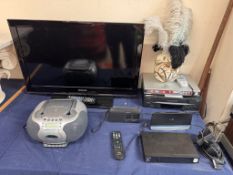 A Samsung flat screen television together with a Sanyo DVD player, Matsui video player,