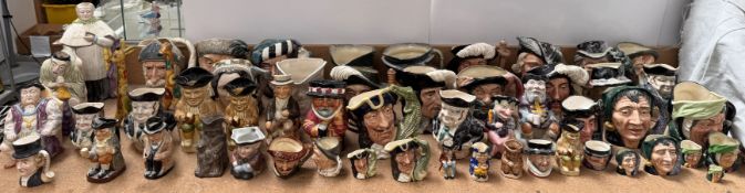 A large collection of Royal Doulton character jugs together with numerous other character and toby