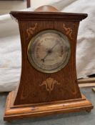 An Art Nouveau oak cased Burlington barometer with a domed top and metal inlay,