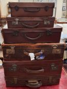 Six assorted graduated suitcases,