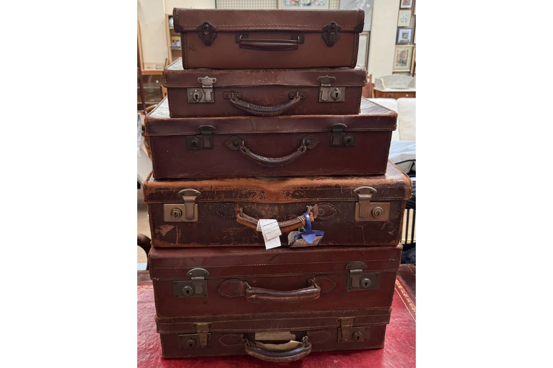 Six assorted graduated suitcases,