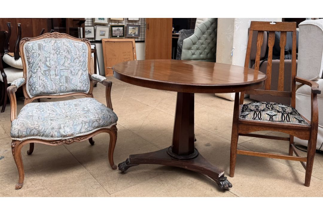 A Victorian mahogany supper table together with an Arts and Crafts style oak elbow chair and an