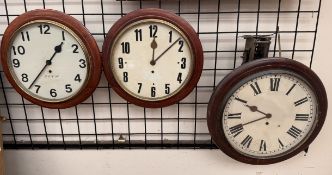 Three railway type wall clocks two with Arabic numerals one with Roman numerals