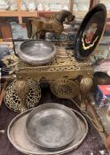 A brass footman with a pierced top and cabriole legs together with a trivet stand, horse door stops,