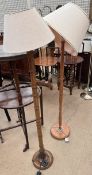 A standard lamp with a faux bamboo column together with another standard lamp