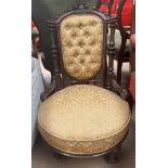 A Victorian walnut nursing chair, with a carved cresting rail,