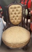 A Victorian walnut nursing chair, with a carved cresting rail,