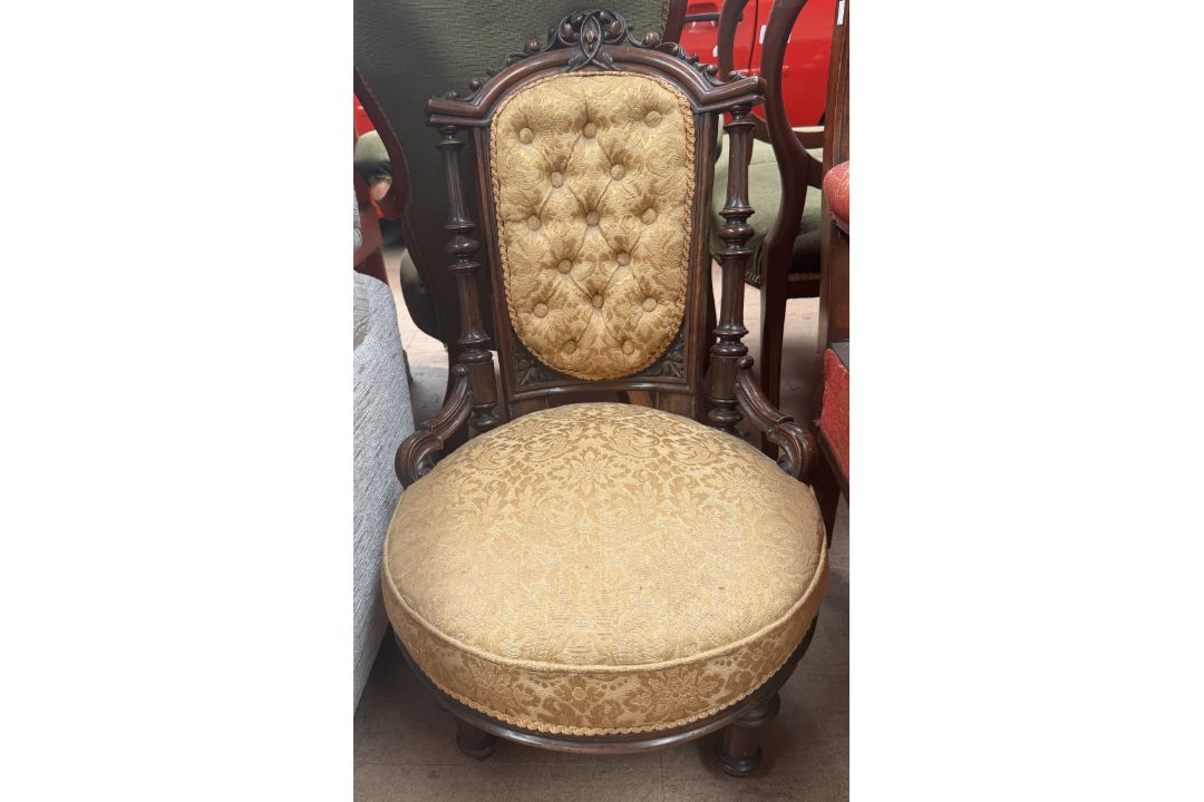 A Victorian walnut nursing chair, with a carved cresting rail,