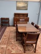 A 20th century oak dining suite, comprising a refectory type dining table on cup and cover legs,