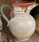 A Clarice Cliff moulded jug decorated with flowers and leaves,