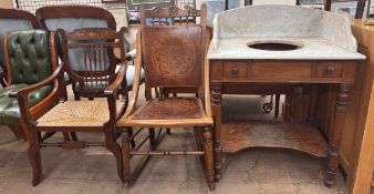 A rocking chair with a panelled back and seat on turned legs together with an Edwardian elbow chair