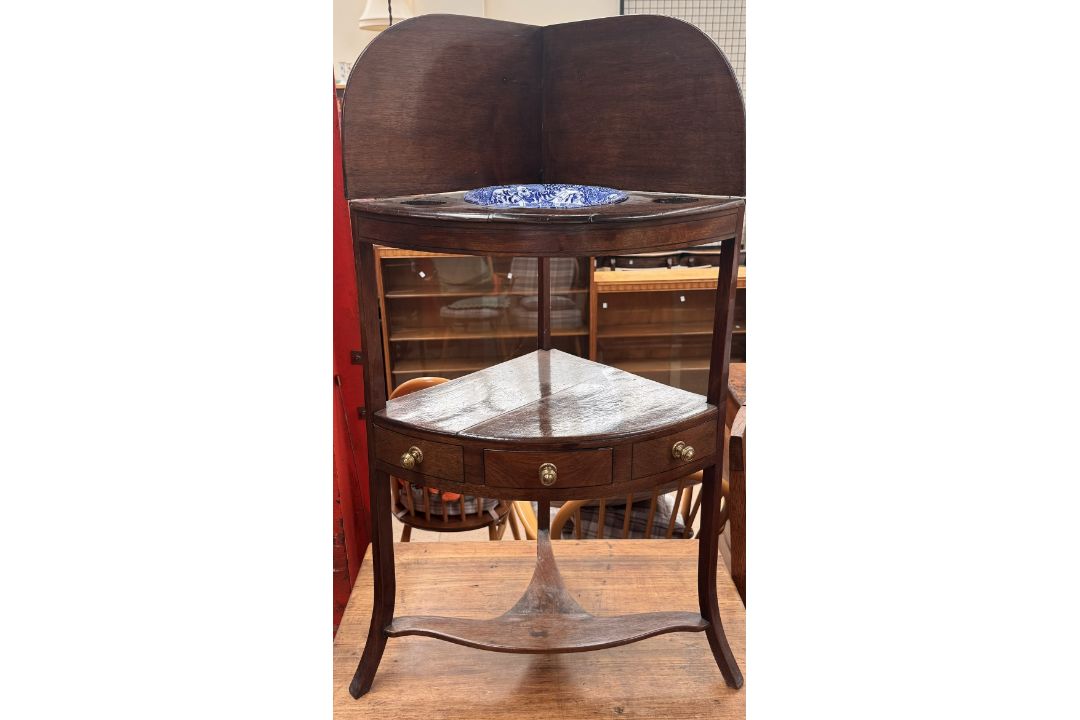 A George III mahogany corner washstand,