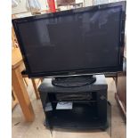 A Panasonic 42" television together with a JVC video recorder and a television stand