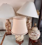 A pair of Chinese porcelain prunus blossom decorated vases converted to table lamps together with