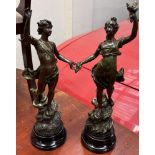 A pair of spelter figures depicting a young girl and a young boy on naturalistic bases,