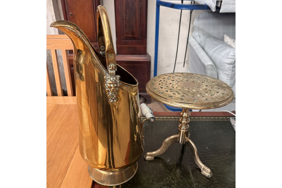 A brass coal scuttle together with a brass trivet