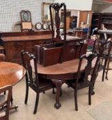 An early 20th century mahogany dining room suite comprising an extending dining table with an oval