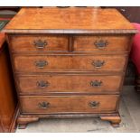 A reproduction walnut chest with a rectangular crossbanded and herringbone strung top above two